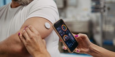 Person monitoring health data with a wearable sensor and smartphone app.