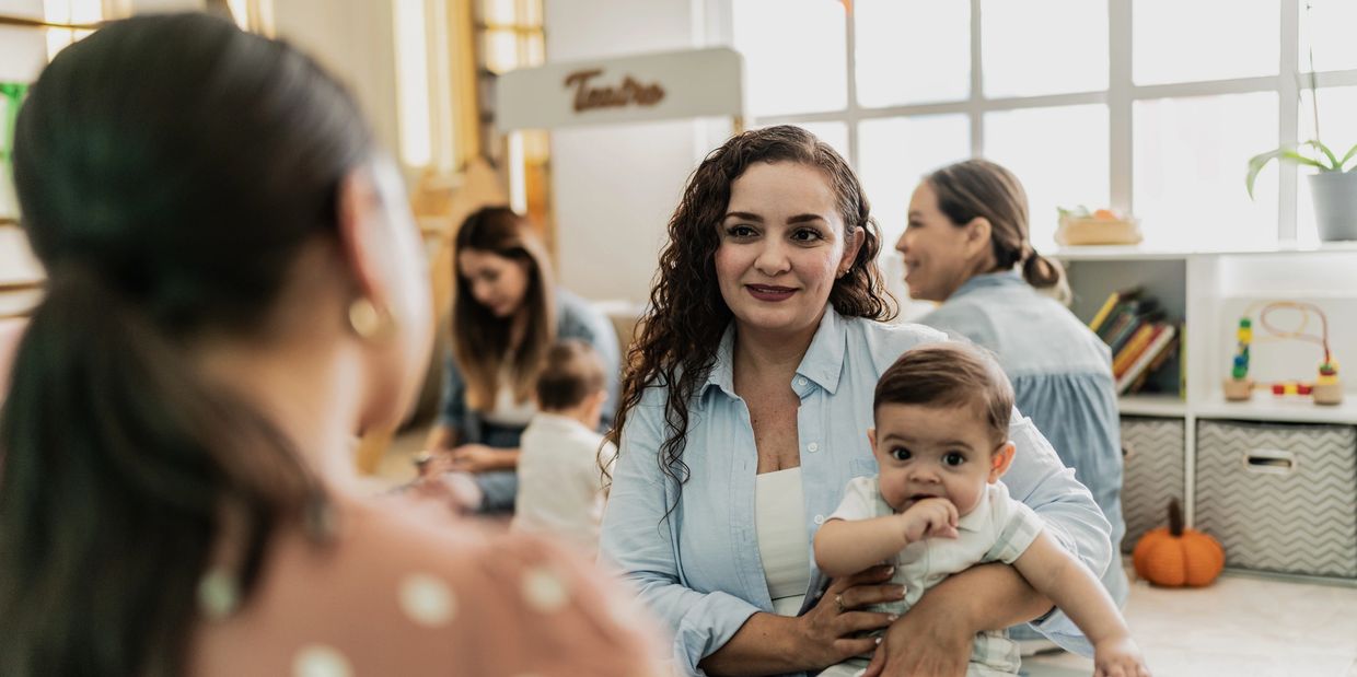 Mothers and babies sharing time in a cozy indoor space.