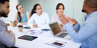 Five office colleagues discussing a project.