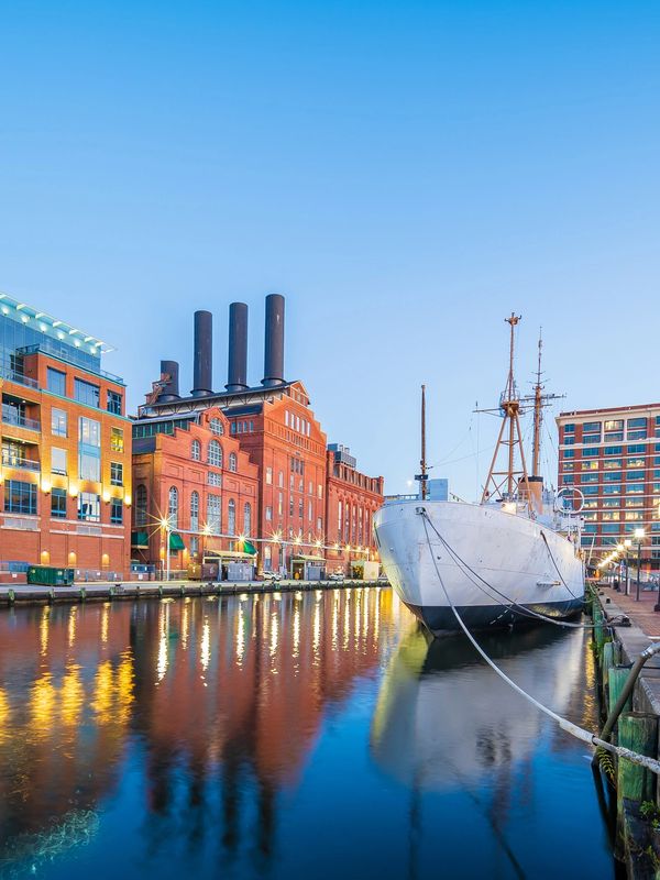 Baltimore Harbor waterfront with historic ship near major convention venues.