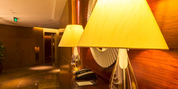 Elegant lamps on a polished wooden surface in a warmly lit interior.
