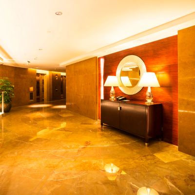 Luxurious hotel corridor with warm lighting and elegant decor.