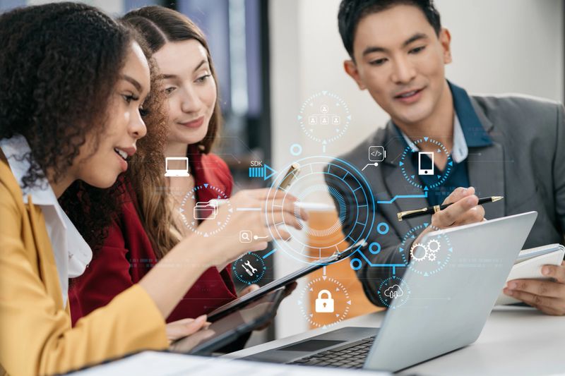 Person using smartphone, tablet  with SDK icon on virtual screen. SDK Software development kit programming language technology concept in office.