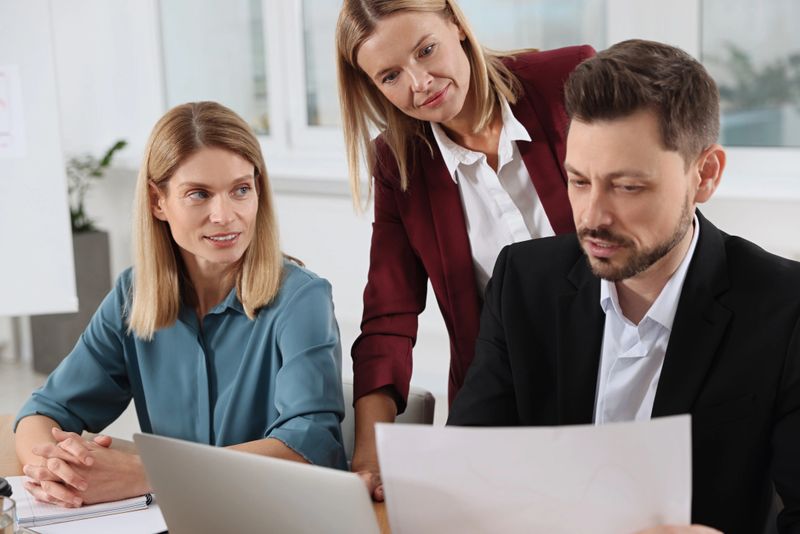Businesswoman having meeting with her employees in office
