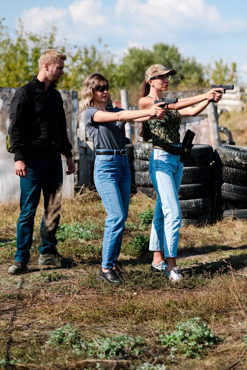 Shooting instructor teaching a women how to properly handle a weapon at the shooting range