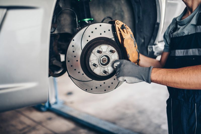 Brake disk and the wheel assembly. Auto repair shop close up photo.