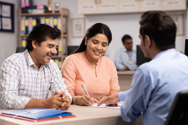Couple signing loan agreement at the bank