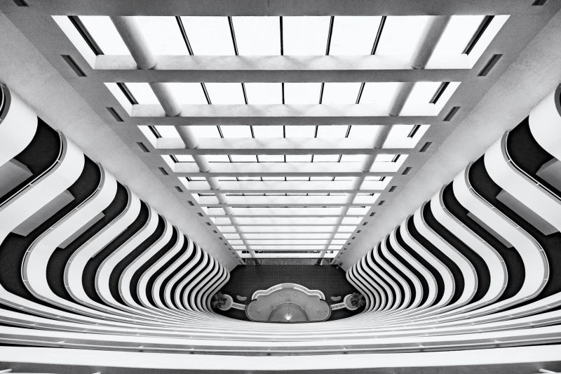 The architectural abstract lines made of by the floors of this atrium located in the common area inside of a 20-floor residential condominium tower.  I shot this image from the upper floors in the hallway areas common to the members and guests of the homeowner's association and provided a metal print to them currently on display in their lobby in exchange for the property release on file signed by a board-member of the association representing the owners of the individual residences contained within the building.  The exact location of the building is on the property release.