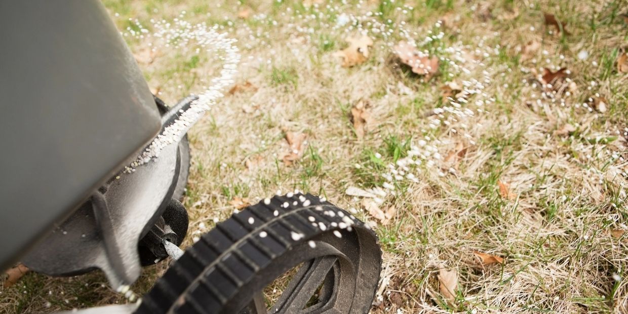 Lawn Care Professional Applying Fertilizer to a Lawn in Fayetteville, NC