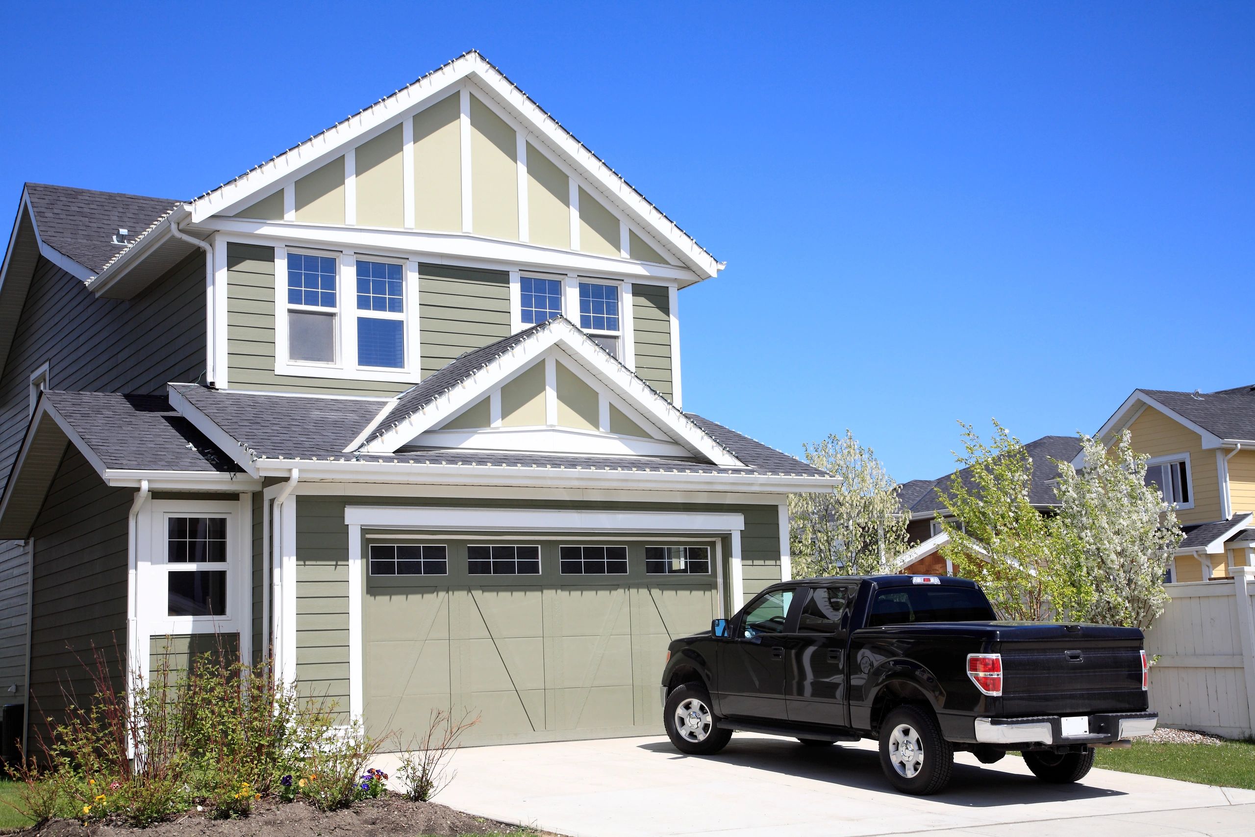 Pickup truck parked in front of a new home