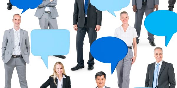 Business professionals with empty speech bubbles on white background.