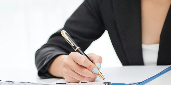 a woman writing with pen
