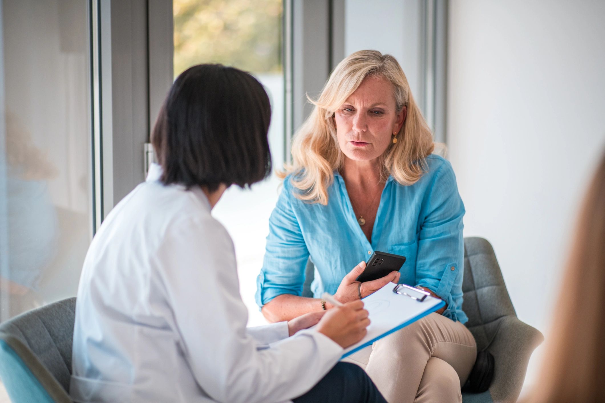 Healthcare provider consulting with patient representing integrative ketamine therapy and coaching p