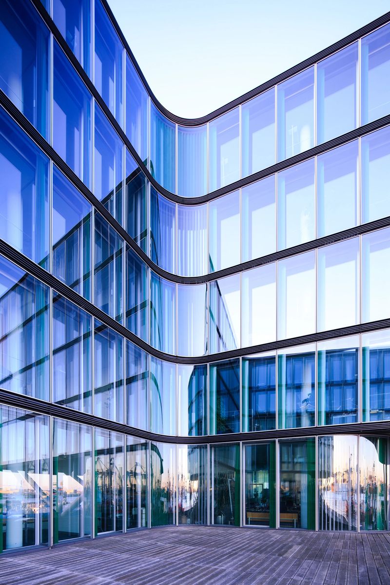 Reflection of the Hamburg harbor i a glass facade of a modern office building.Taken with: Canon 5D Mark 3 / 17mm TS-E
