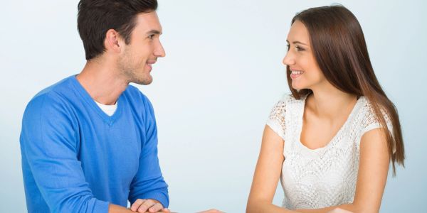 A smiling couple looking at each other.