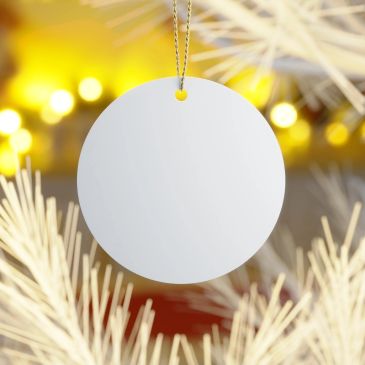 Blank round white Christmas ornament hanging on tree.
