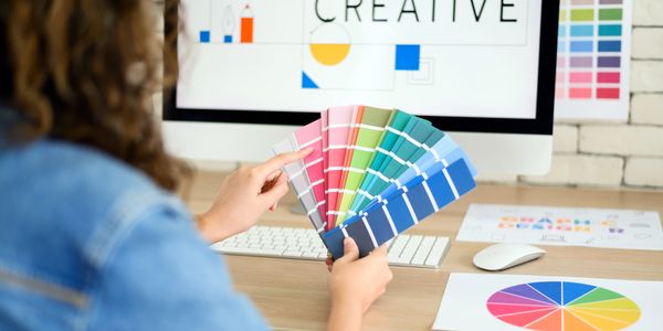person holding and looking at a color wheel to select colors for a project