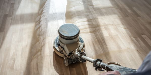 sanding hardwood floor with sander machine