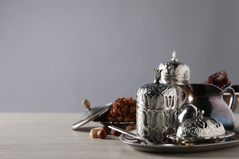 Tea, date fruits and Turkish delight served in vintage tea set on wooden table, space for text