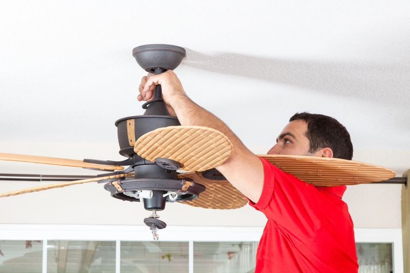 Men installing ceiling fan.