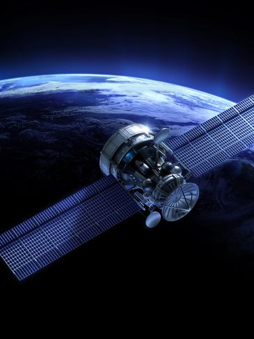 Satellite orbiting Earth with solar panels extended.