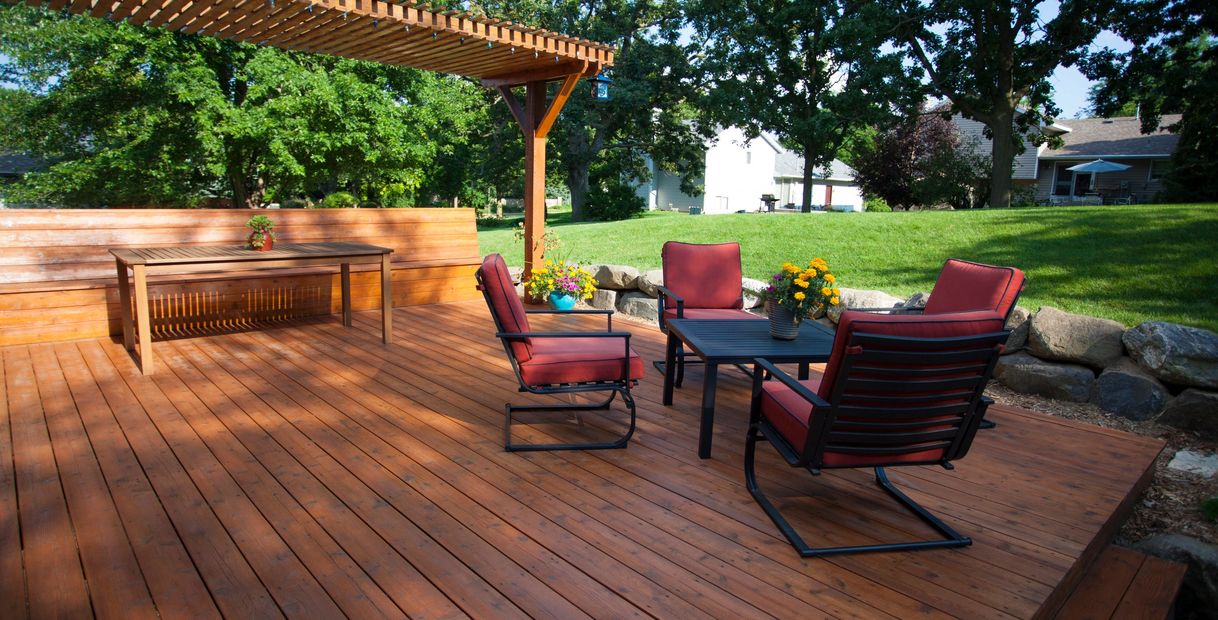 Beautiful wooden deck with outdoor dining area.