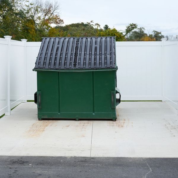 Dumpster pad cleaning in progress using water and detergents washing in Springfield Missouri