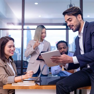 Four diverse professionals collaborating in a modern office.