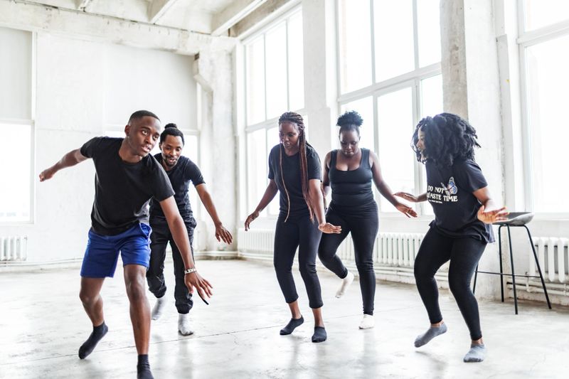 Young black males and females dancing in exercise room before dance performance. Dance rehearsal