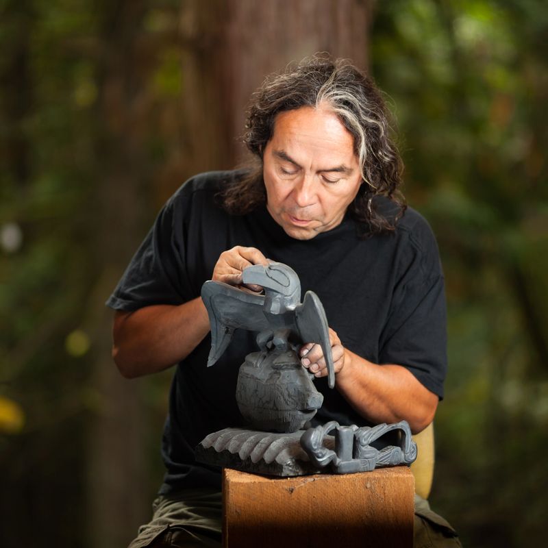 First Nations - Haida - carver working on argillite stone sculpture.  