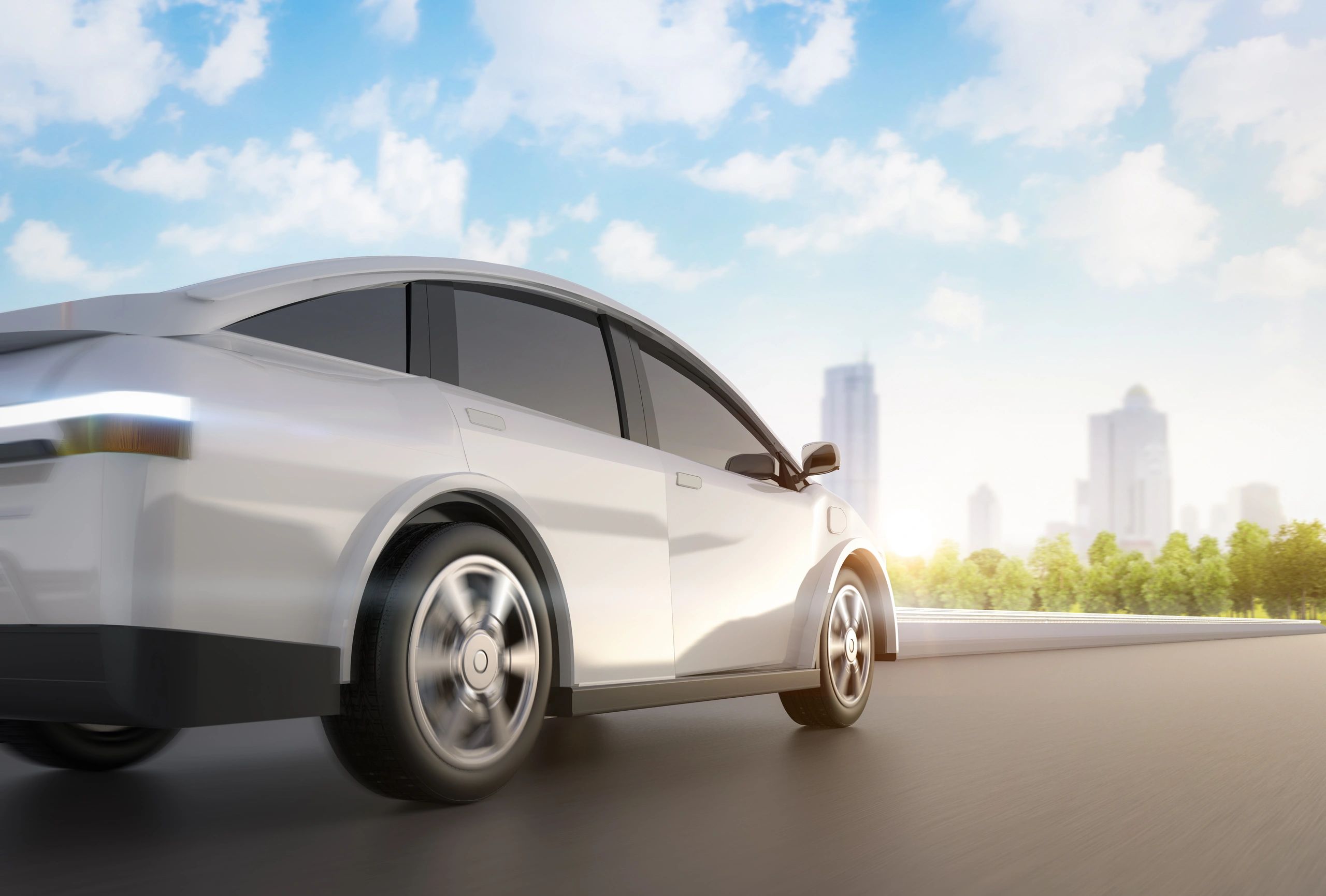 White futuristic car driving on a road under a sunny sky.