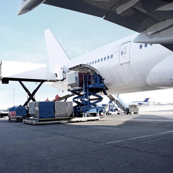 Loading cargo into a plane at an airport.