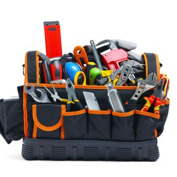 A black and orange tool bag filled with various hand tools.
