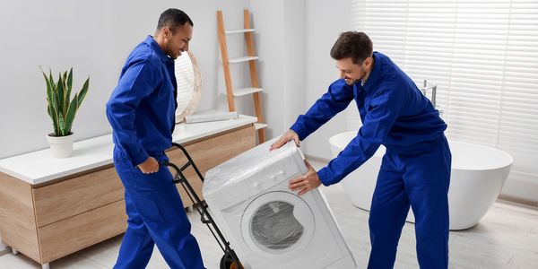 Appliance movers removing a dryer