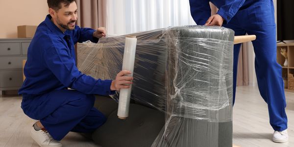 Professional moving crew wrapping furniture in Melbourne"