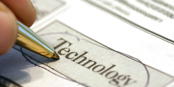 Pen circling the word 'Technology' on paper.