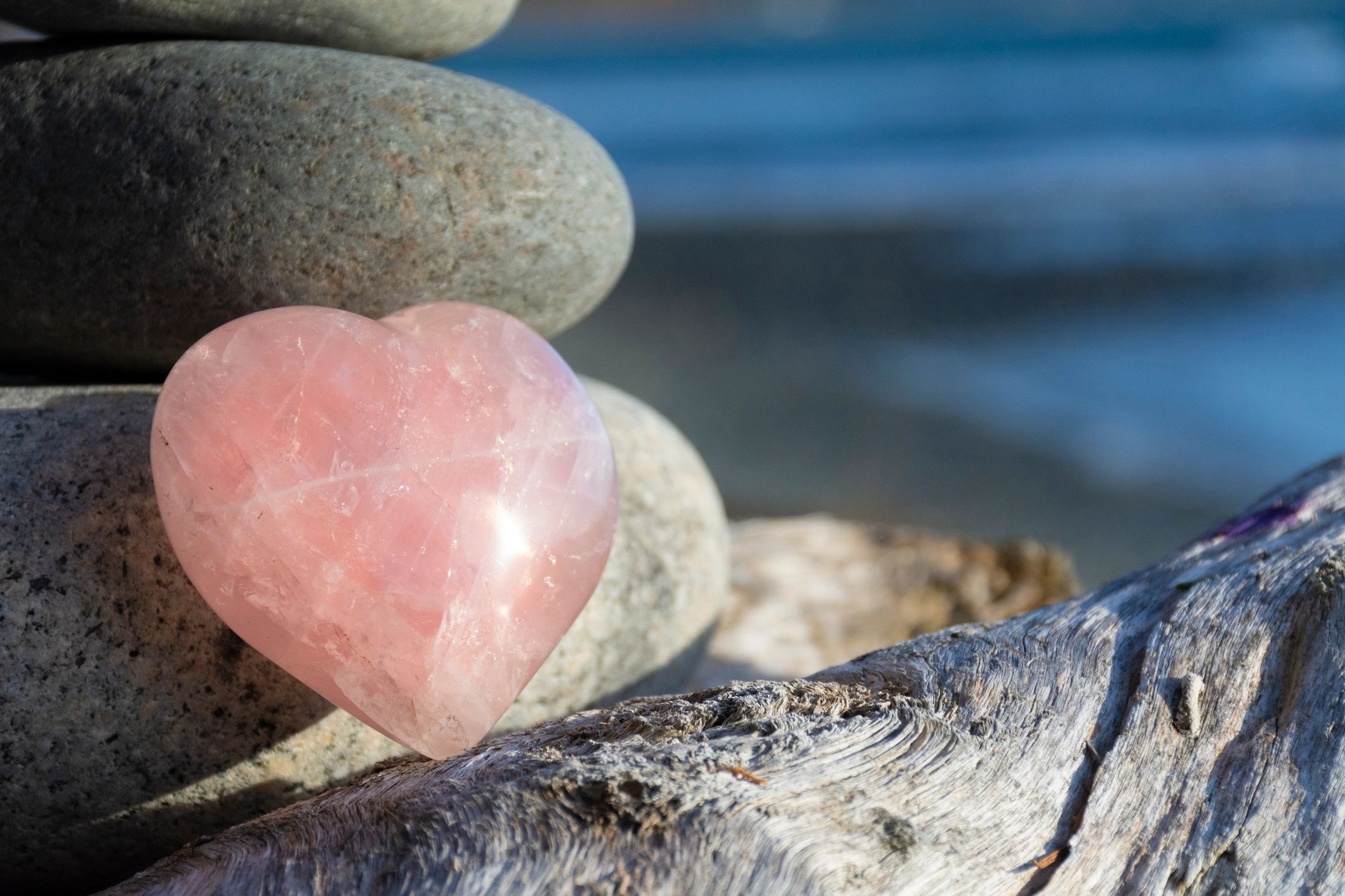 rose quartz stone on rocks by the lake