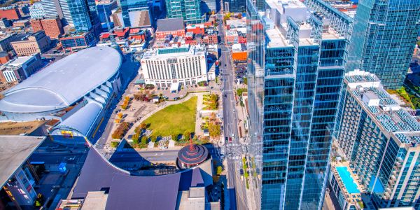 Aerial view of a cityscape with tall buildings and a park.