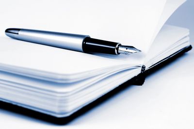 Blank page with a pen waiting for the story to be written