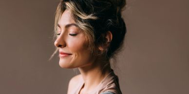 Peaceful woman with eyes closed and a soft smile.