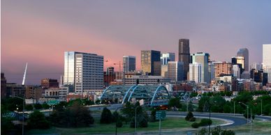 Downtown city skyline during sunset with a park in the foreground.