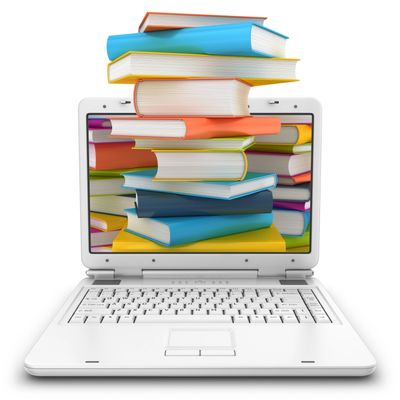 Laptop with a stack of colorful books on and displayed on its screen.
