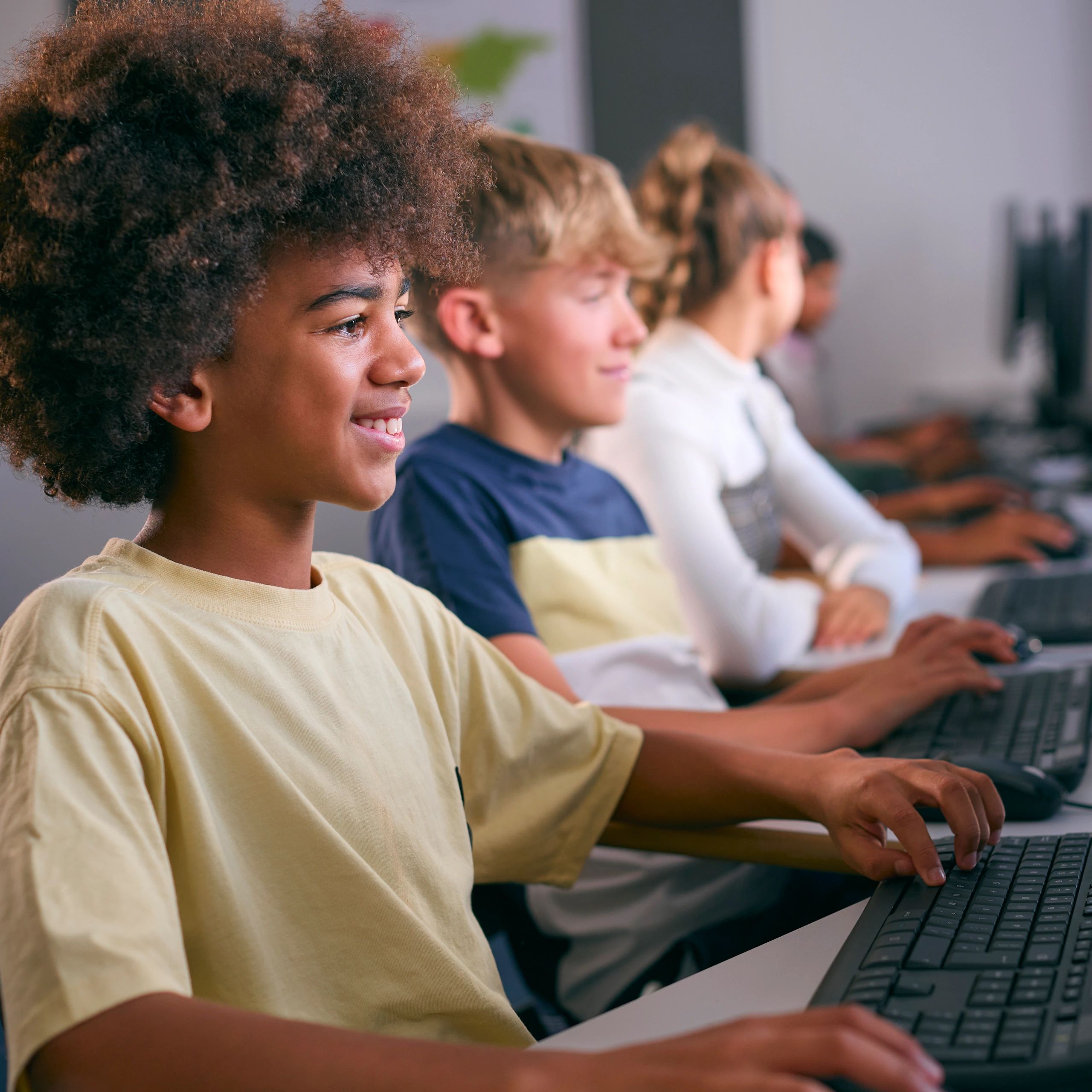 Students engaged in computer class using desktops.