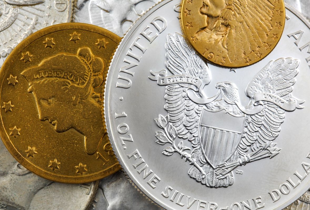 Close-up of assorted gold and silver coins.