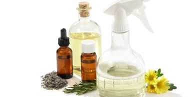 Various essential oils and herbs with a spray bottle.