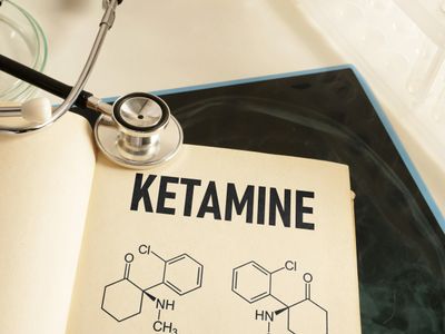 Open book page showing ketamine chemical structure with a stethoscope.