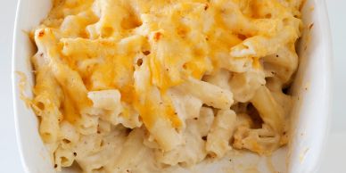 Creamy baked macaroni and cheese in a white dish.