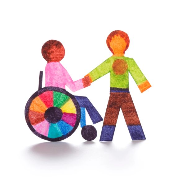Colorful paper cutouts of a person in a wheelchair holding hands with another person.