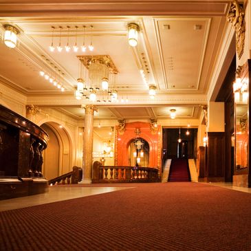Elegant hotel lobby with warm lighting and luxurious decor.