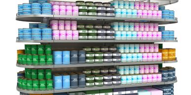 Supermarket shelf filled with various canned seafood products organized by color.